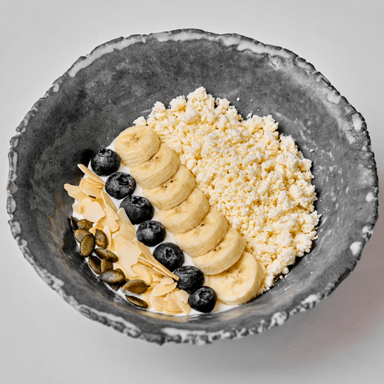 Cottage cheese bowl with fresh berries, served with honey
