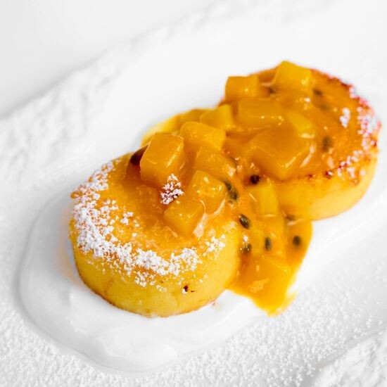 Syrniki with fresh passion fruit and mango