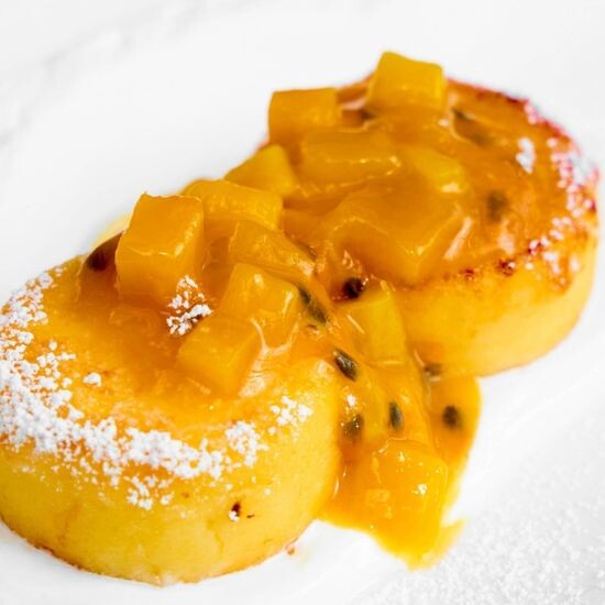 Syrniki with fresh passion fruit and mango